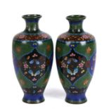 A pair of late 19th century Japanese Meiji period cloisonne vases decorated with butterflies and