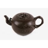 A Chinese Yixing teapot of globular form with branch handle and spout, impressed four character seal