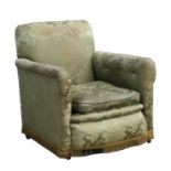 A late 19th century upholstered armchair on bun feet.Condition Report There is a small rip along the