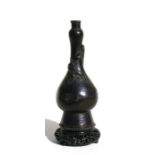 A Chinese Ming vase decorated with a chilong on a later intricately carved hardwood stand, 16cms (