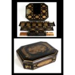 A 19th century Chinese Export lacquer games box decorated with gilded figures on a black ground,
