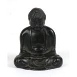 A patinated spelter figure in the form of a seated Buddha with seven character mark to underside,