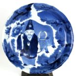 A 19th century Japanese blue & white charger decorated with a robed figure leading an ox, 38cms (