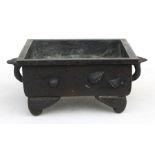 A Chinese bronze square form censer decorated with seashells with Lingzi handles, 15cms (6ins)