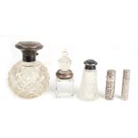 A silver cased scent bottle; together with three silver mounted bottles and a white metal