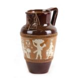 A stoneware jug decorated with Egyptian figures, 17cms 96.5ins) high.