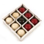 Nine late 19th century ivory billiard balls, four red, one brown and four white, each 4cms (1.