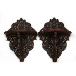 A pair of Chinese carved and pierced wall shelves decorated with dragons, phoenix and bats,