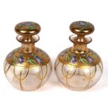 A pair of gilt and enamel decorated glass scent bottles of globular form, 15cms (6ins) high.