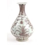 A Chinese bottle vase decorated with scrolling foliage in underglaze red, 32cms (12.5ins) high.