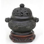 A Chinese bronze censer and cover decorated in relief with mythical beasts and having two lion