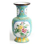 A Chinese enamel vase decorated with flowers on a turquoise ground, 29cms (11.5ins) high.