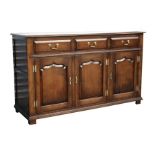 A Stanley Cumper of Salisbury oak sideboard with three frieze drawers above cupboards, 140cms (