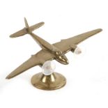A WW2 brass model of the de Havilland DH.98 Mosquito fighter bomber on its brass stand. Marked on
