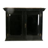 A Victorian ebonised collector's cabinet with two bevelled glazed doors enclosing a shelved mirror