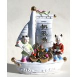 A 20th century Chinese porcelain group, figures in a boat. 39cm (15.25ins) high.