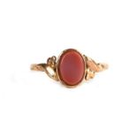 A 9ct gold ring set with an oval hardstone, approx UK size 'P'.