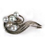 A Mikimoto silver pearl cluster brooch with five grey cultured pearls with pink overtones, 5cms (