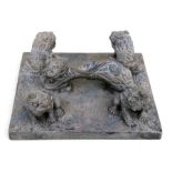 A large Chinese soapstone scroll weight carved with four fo dogs and a rui sceptre handle, 29cms (