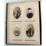 A Victorian green leather photograph album containing mainly family portraits.