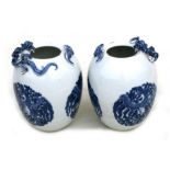 A pair of Chinese blue & white egg shaped vases with applied bat and chilong, four character blue