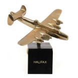 A brass model of the WW2 heavy bomber the Handley Page Halifax mounted on its brass base. Wingspan