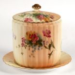 A Victorian Royal Worcester biscuit barrel on stand decorated with flowers on a blush ivory