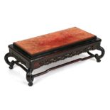 A Chinese hardwood stand, the velvet covered rectangular top above a pierced frieze, on four legs