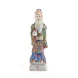 An 18th / 19th century Chinese figure of an Immortal holding a peach, 22cms (8.5cms) high.