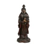 A Chinese lacquered wooden figure depicting a robed man holding a sack, 26cms (10.25ins) high.