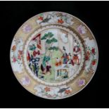 An 18th / 19th century famille rose plate decorated figures in a garden. 23cm (9 ins) diameter
