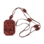An antique Chinese cinnabar lacquer rectangular pendant, carved with boys, later mounted as a