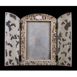 A Chinese Canton Export ivory strut picture frame, the pair of pierced dorrs decorated with coiled
