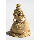 A 19th century Chinese ivory figural puzzle ball stand depicting a figure riding a stylised toad,