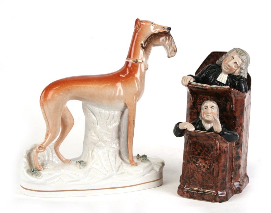 A 19th century Staffordshire pottery group - The Sleeping Judge and Clerk - 24cms (9.5ins) high;