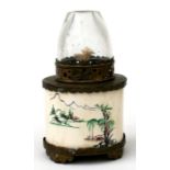 An early 20th century ivory and brass mounted opium lamp, decorated with figures in a landscape