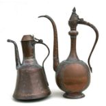 A Turkish / Islamic copper coffee pot; together with another similar smaller, 43cms (17ins) high.