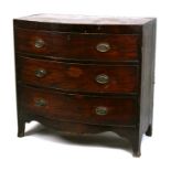 A Regency mahogany bow fronted chest of three long graduated drawers, on splay bracket feet,