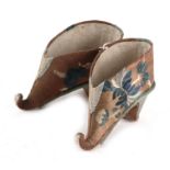 A pair of Chinese silk embroidered shoes for bound feet, circa 1900, 10cms (4ins) long.