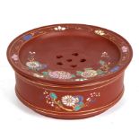 A Chinese Yixing pottery drainer on stand decorated with flowers in enamel colours, 19cms (7.5ins)