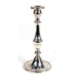 A sterling silver weighted single candlestick, 24cms (9.5ins) high.