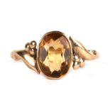 A 9ct gold dress ring set with a large oval pale yellow stone, possibly citrine, approx UK size '