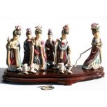 A late 19th / early 20th century Japanese polychrome ivory group of six Geisha girls and two dogs,