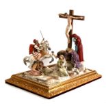 A large Capodimonte porcelain figural group depict Christ's Crucifixion, mounted on a gilded