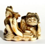 A 19th century Japanese ivory netsuke in the form of a robed woman with an oni, signed '