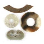 Two Chinese jade bi discs, the largest 7.8cms (3.1ins) diamter; together with two other pieces of