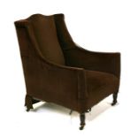 An Edwardian brown velour upholstered armchair.