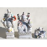 Three 20th century Chinese porcelain figures of the happy Buddha with children, the largest 32cm (
