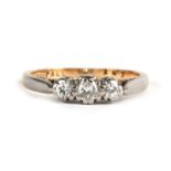 An 18ct gold three-stone diamond ring, approx UK size 'N'.