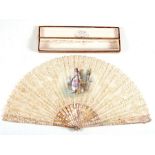 A 19th century mother of pearl and lace fan, the central panel hand painted with a scene of a